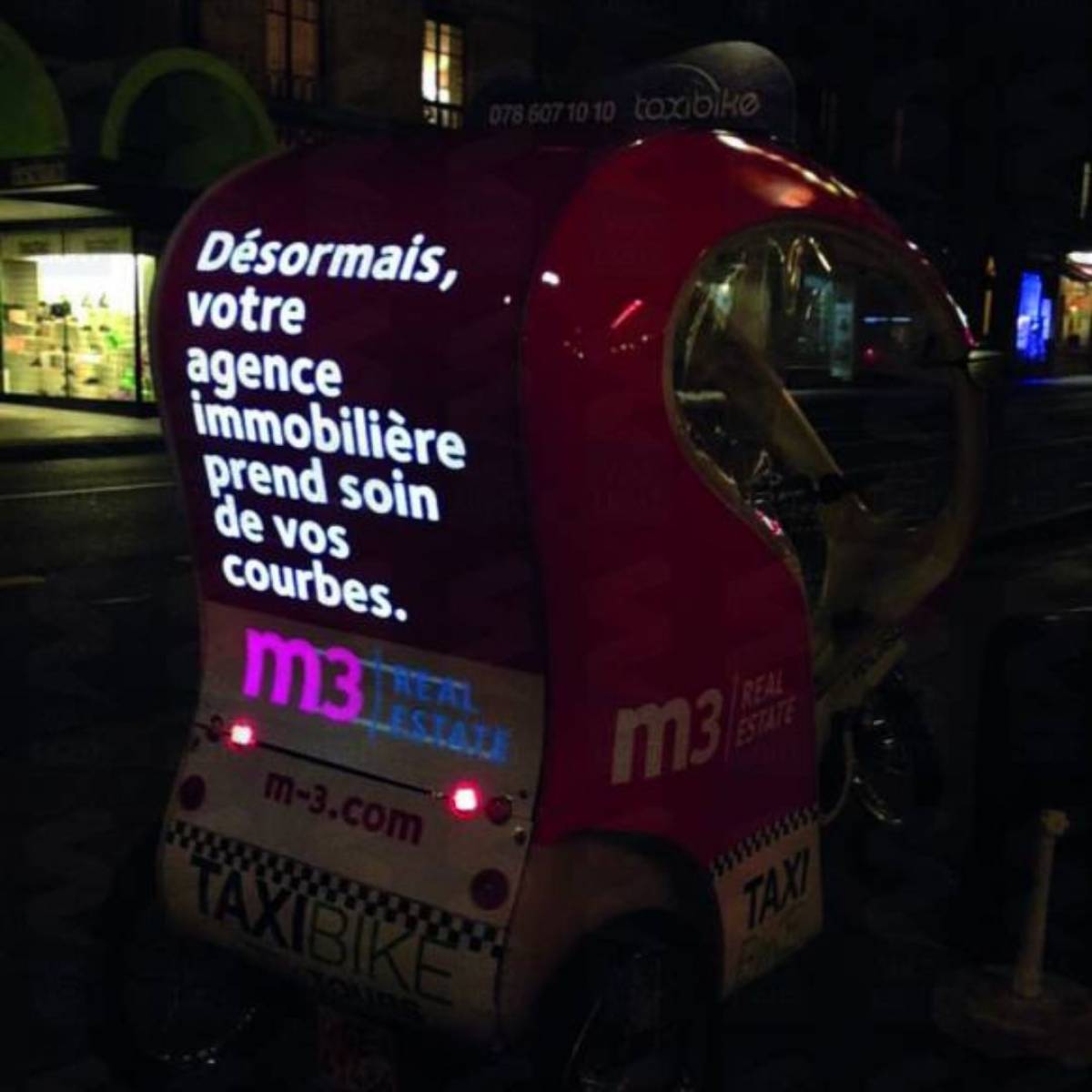 Flocage lumineux agence immobilière M3 sur un Taxi-Bike à Genève
